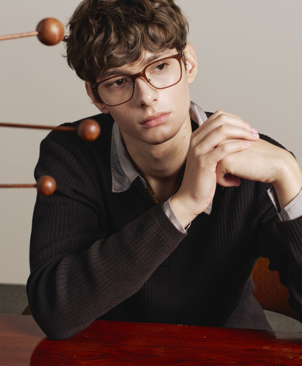 Man in CARIN glasses, seated