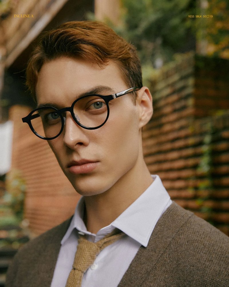 Man in dark VYCOZ acetate glasses in a garden