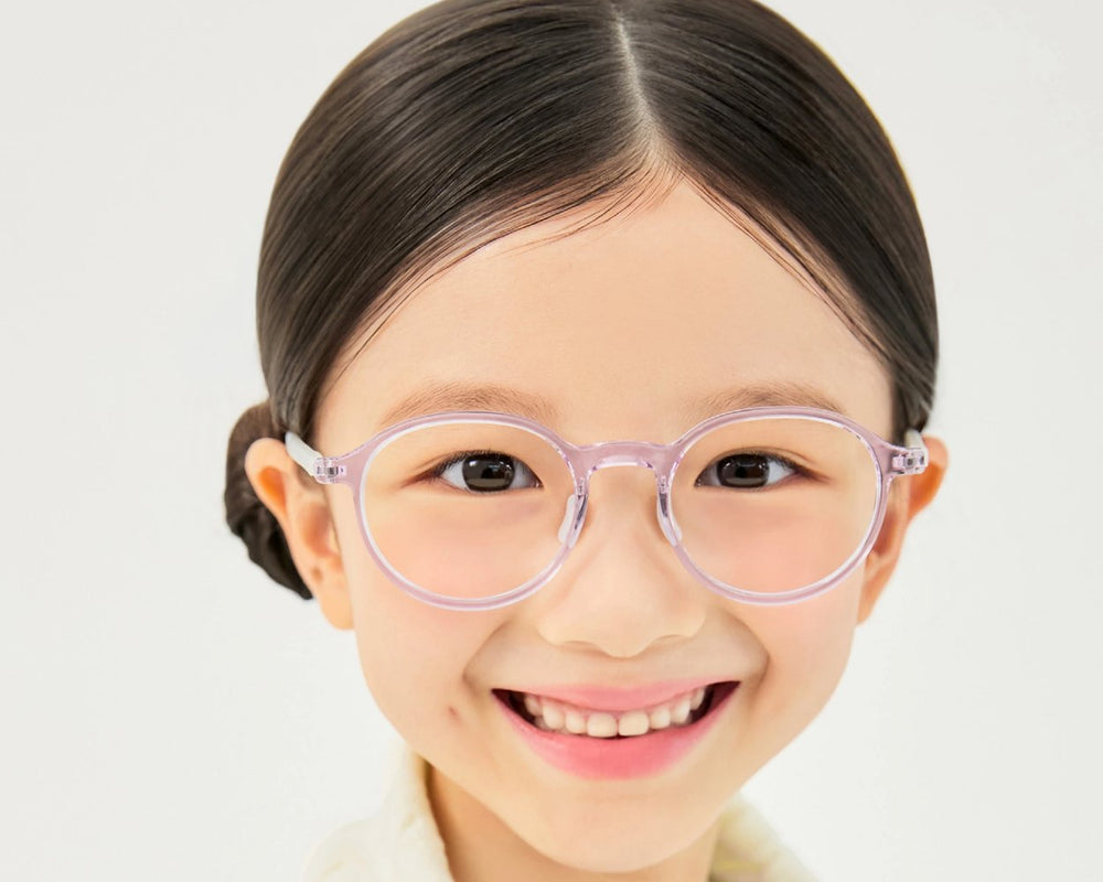 Smiling child in clear VYCOZ Gentle Kids glasses