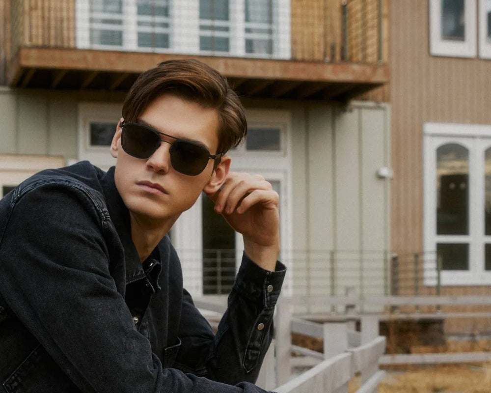 Man in VYCOZ sunglasses on a wooden porch